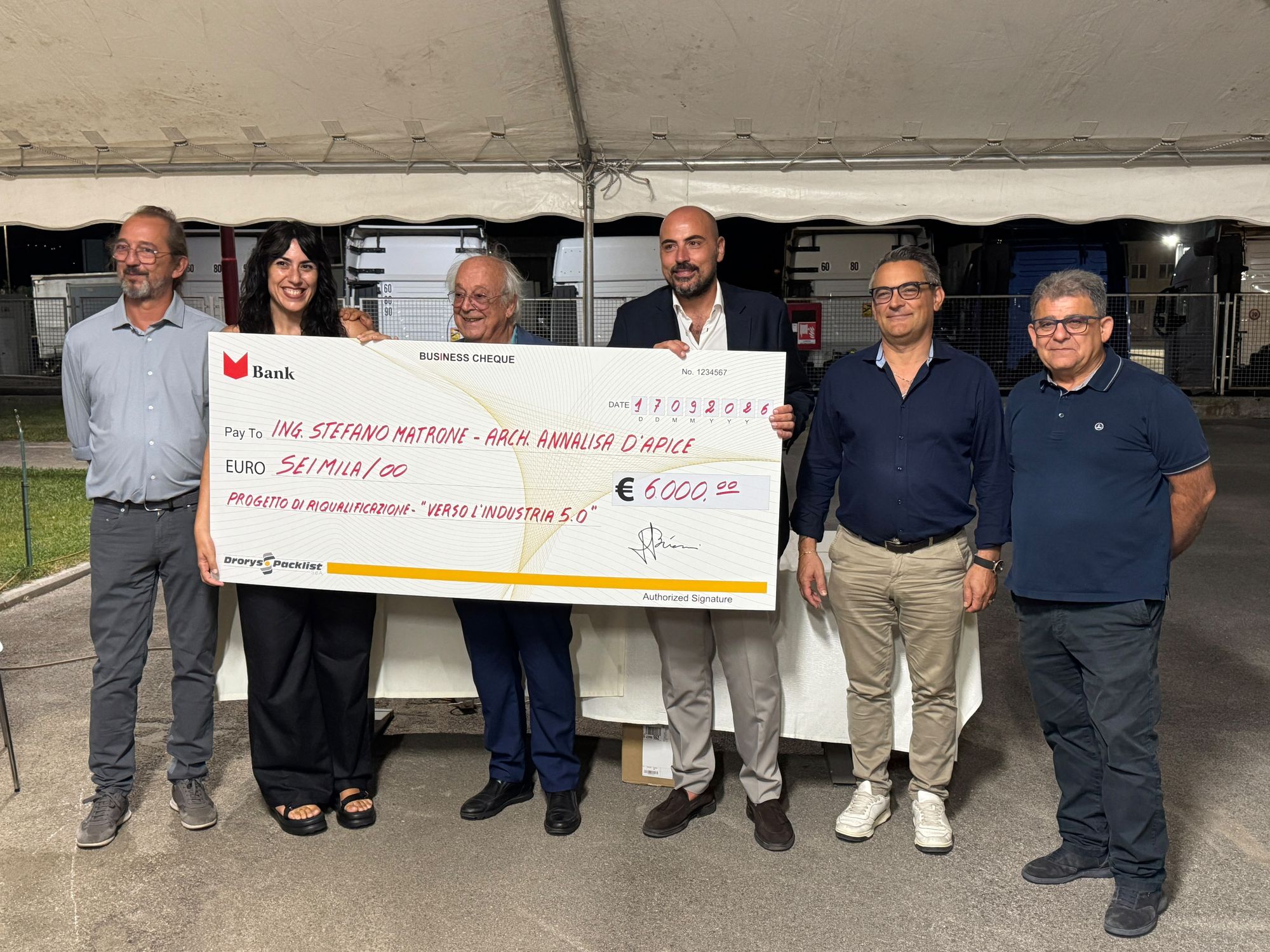 Presentation of the first-place check to the winners under the big top